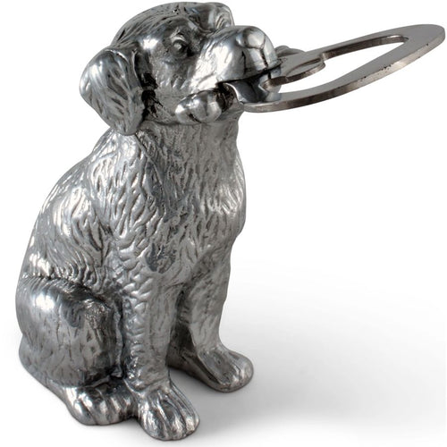 Metallic dog-shaped bottle opener on a white background
