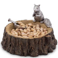 Decorative bowl with a squirrel figurine and pistachios on a white background