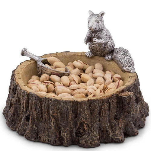 Decorative bowl with a squirrel figurine and pistachios on a white background