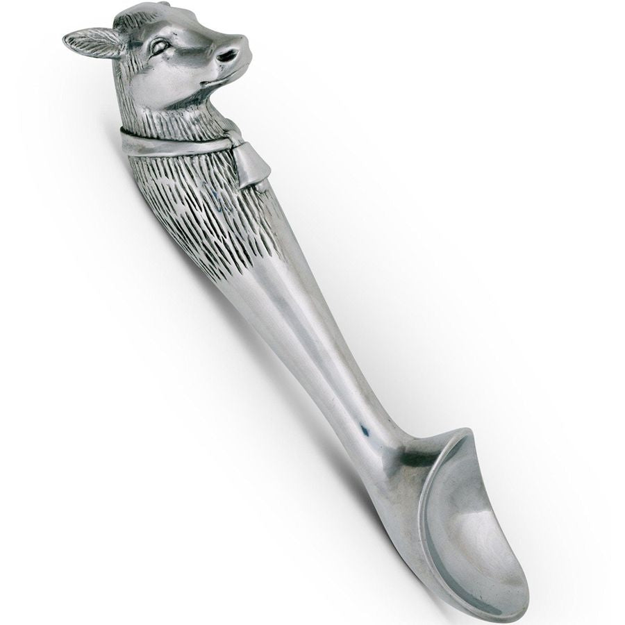 Silver cow head spoon on a white background