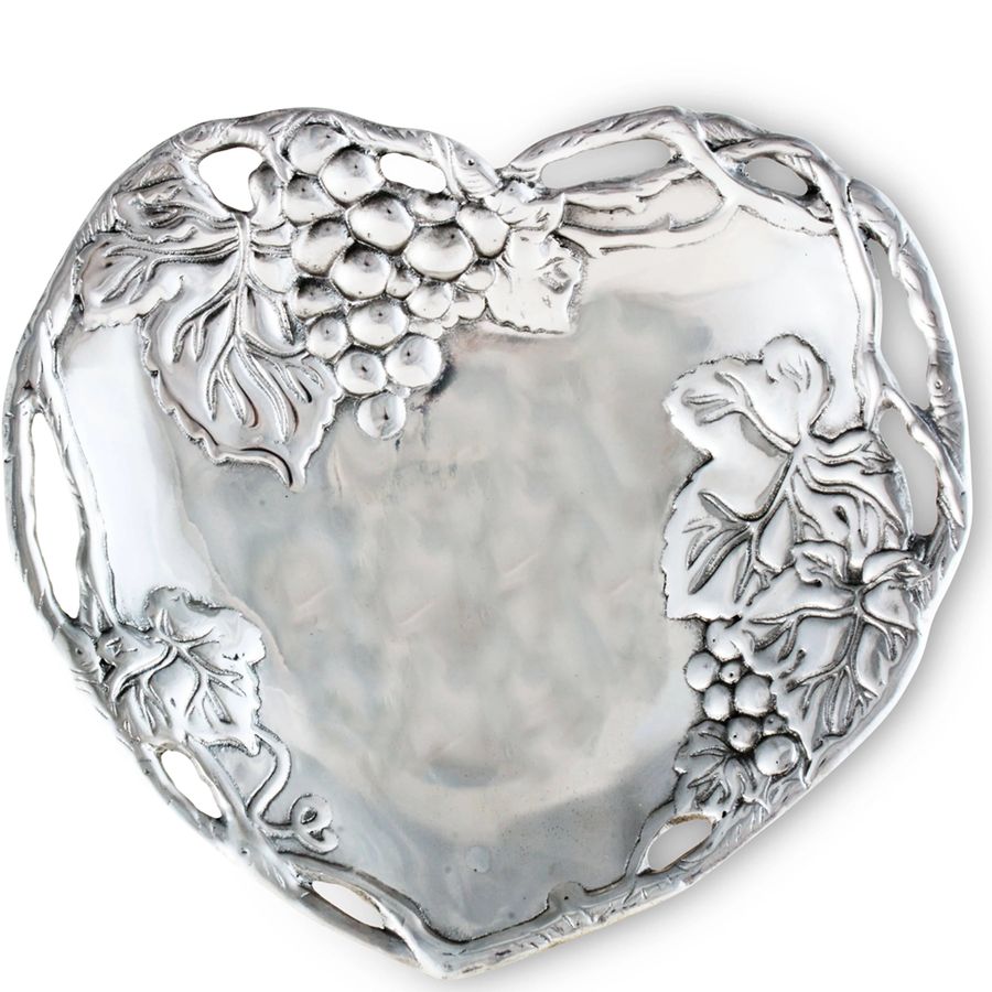 Silver heart-shaped dish with grapevine design on a white background