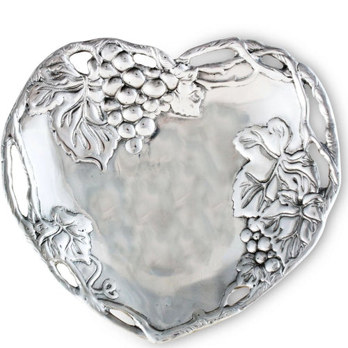 Silver heart-shaped dish with grapevine design on a white background