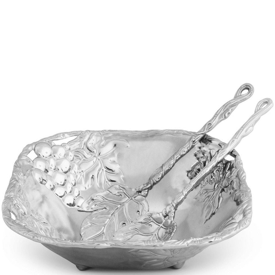 Decorative silver bowl with a spoon on a white background