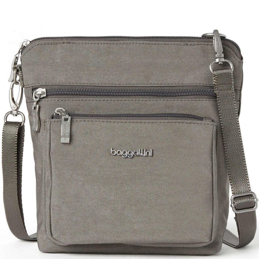 Gray crossbody bag with multiple zippers and 'baggallini' branding on a white background