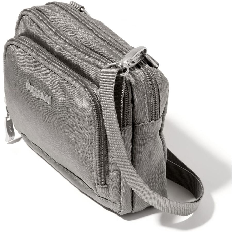 Gray shoulder bag with multiple zippers on a white background