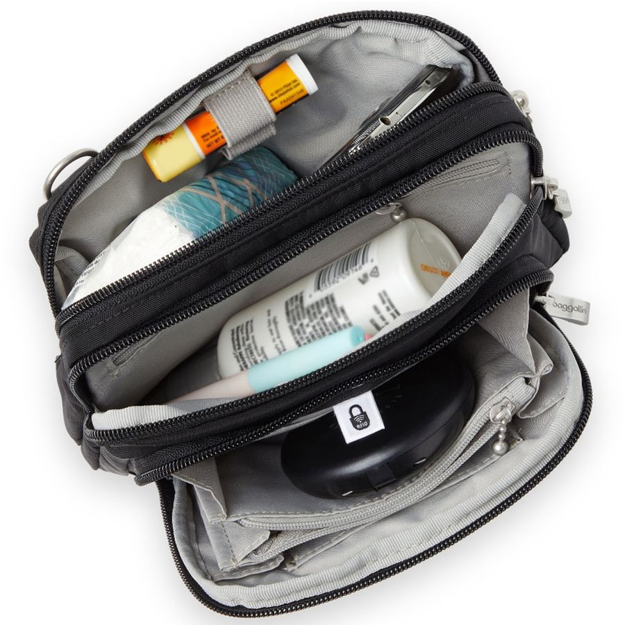 Open travel bag with toiletries and electronic device on a white background