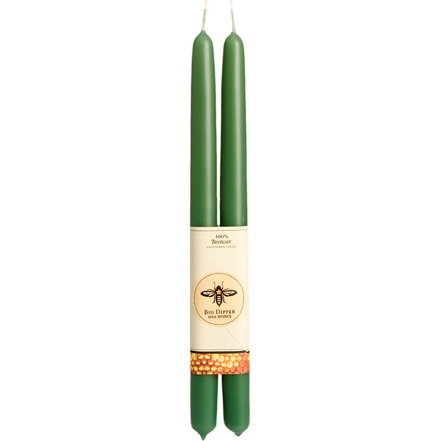 Two green candles with a label on a white background