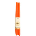 Two orange candles with a visible brand label on a white background
