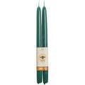 Two green candles with a label on a white background