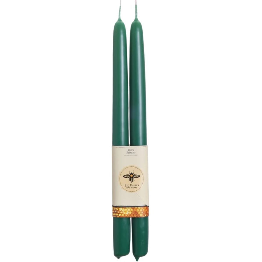 Two green candles with a label on a white background