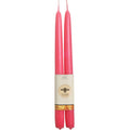 Two pink candles with a label on a white background
