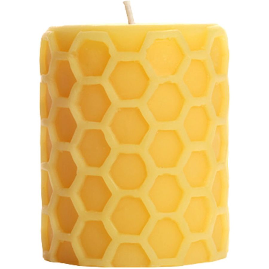 Yellow candle with honeycomb pattern on a white background