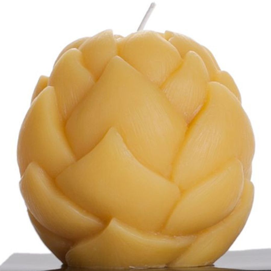 Beeswax candle shaped like an artichoke on a white background