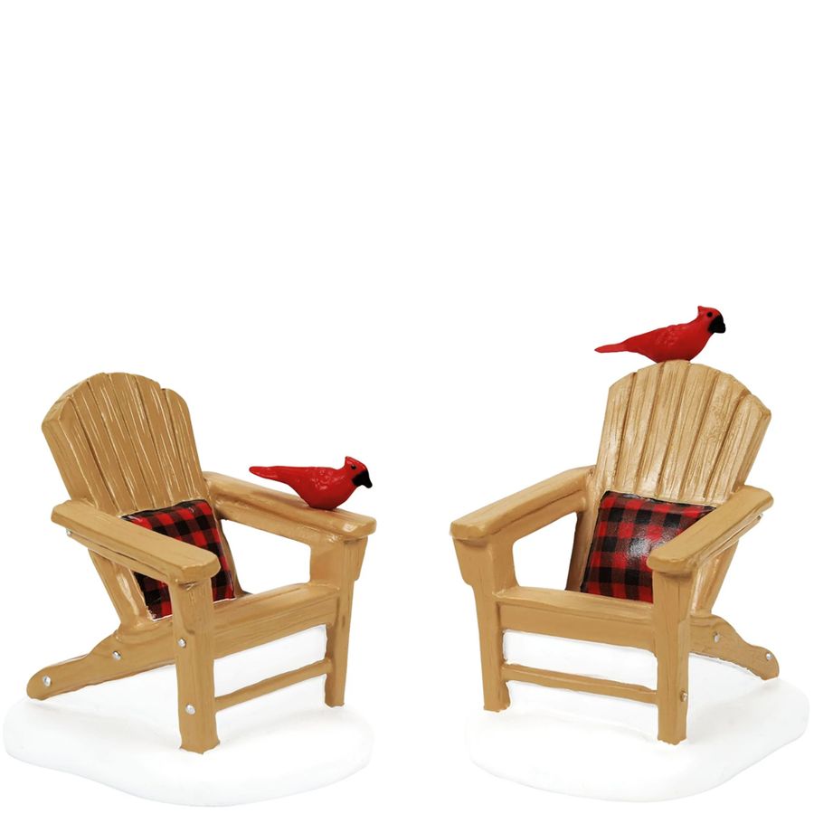 Two wooden Adirondack chairs with red cardinals on a white background