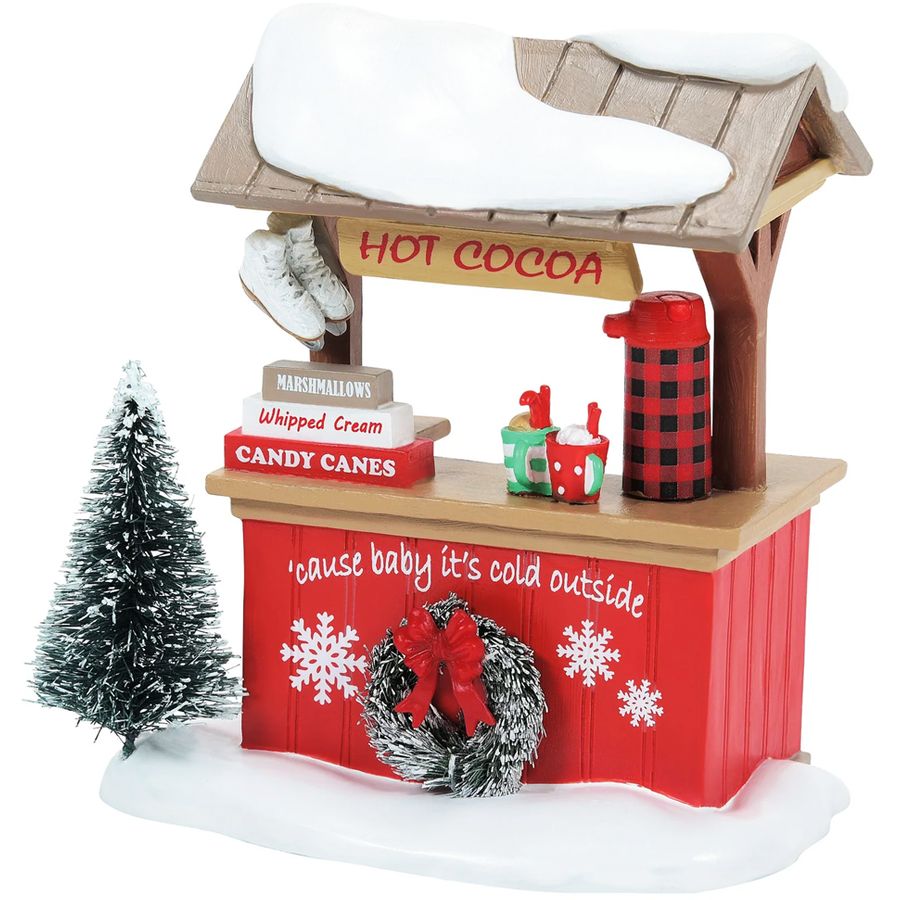 Figurine of Santa Claus handing a candy cane to a child on a white background