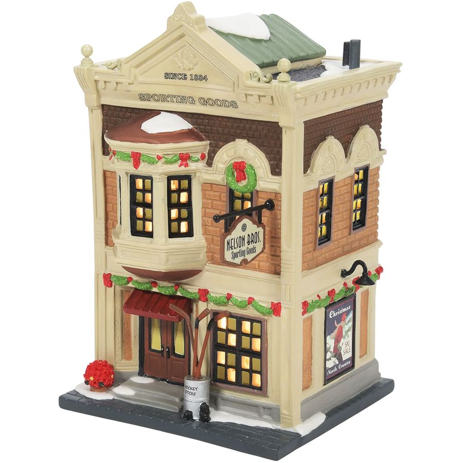 Decorative model of a two-story building with lit windows and festive decorations on a white background.