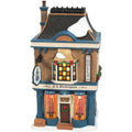Decorative toy shop model with stained glass windows and a sign reading 'T.L. Buckingham Doll Shop'.