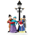 Decorative figurine of four people singing by a street lamp on a white background