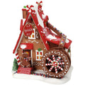 Decorative gingerbread house with candy details on a white background