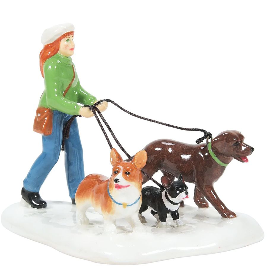 Figurine of a person walking three dogs on a white background