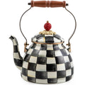 Decorative teapot with checkered pattern and wooden handle on a white background