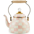 Checkered pink and white teapot with a wooden handle on a white background