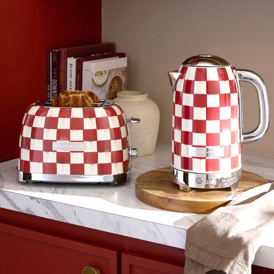Red and white checkered toaster and kettle on a kitchen counter.