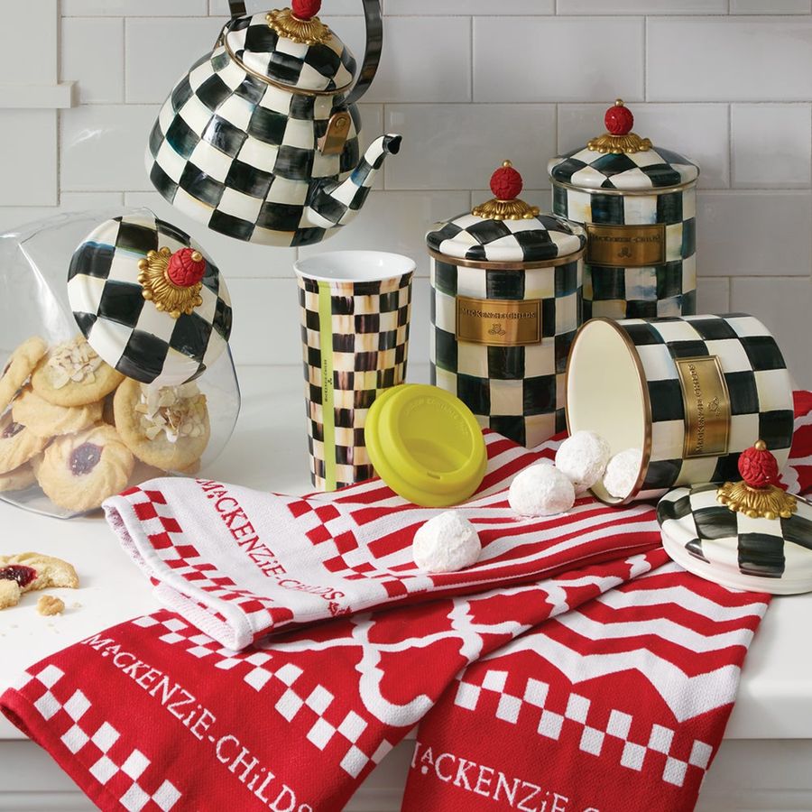 Decorative kitchen items with checkered pattern on a white tiled wall background
