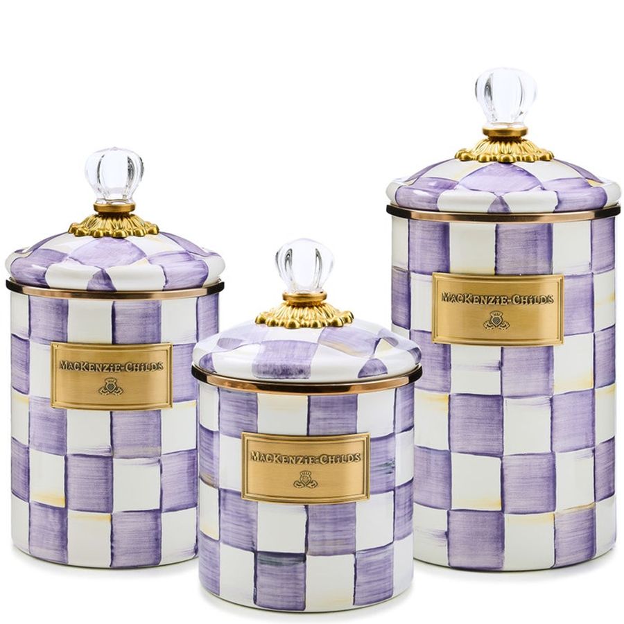 Set of three decorative canisters with purple and white checkered pattern and gold accents.
