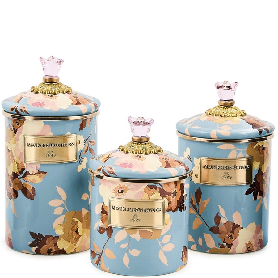 Set of three floral design canisters.