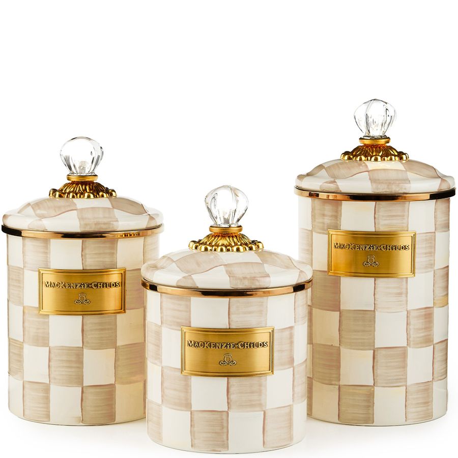 Set of three decorative canisters with checkered pattern and gold accents on a white background