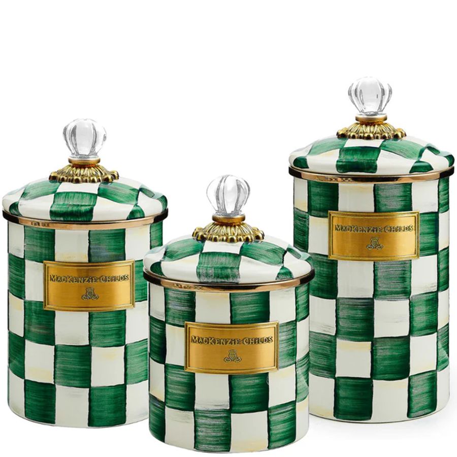 Set of three green and white checkered canisters with gold lids on a white background