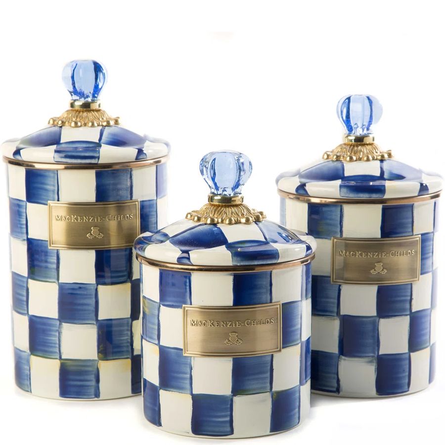 Set of three blue and white checkered canisters with gold accents on a white background