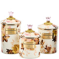 Set of three decorative jars with floral patterns and gold accents on a white background