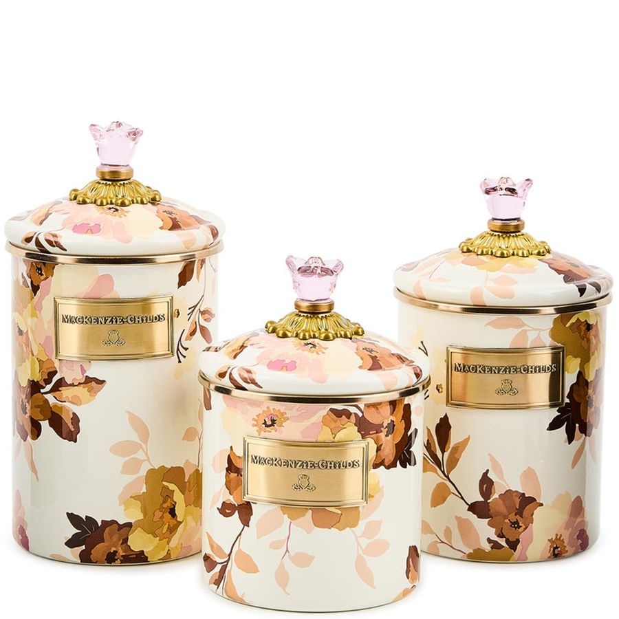 Set of three decorative jars with floral patterns and gold accents on a white background
