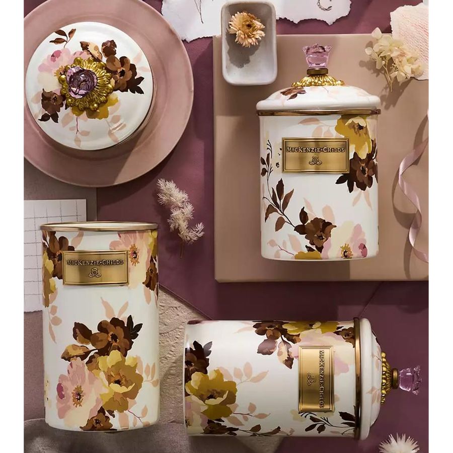 Decorative canisters with floral patterns on a table