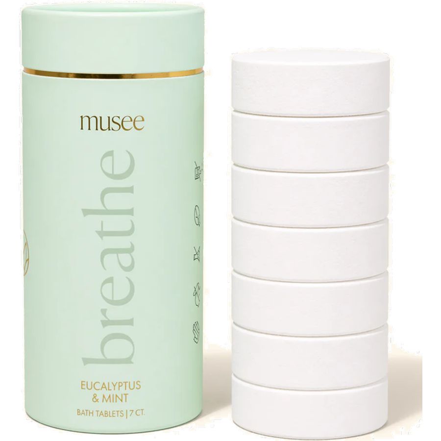 Musee 'breathe' bath tablet container with multiple white tablets on a light background