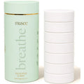 Musee 'breathe' bath tablet container with multiple white tablets on a light background