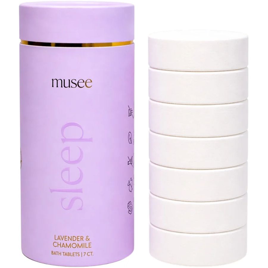 Purple container labeled 'musee' with 'sleep' and bath tablets on a white background