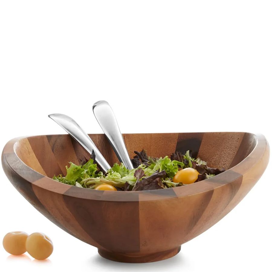 Wooden salad bowl with silver utensils and salad on a white background