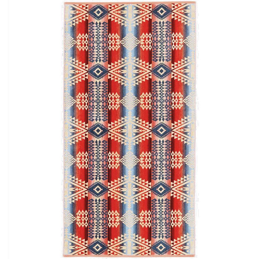Patterned rug with red, blue, and beige colors on a white background