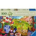 Ravensburger puzzle box with a scenic illustration of a garden and beach.