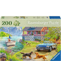 Ravensburger puzzle box with a scenic design featuring a house, boat, and dogs.