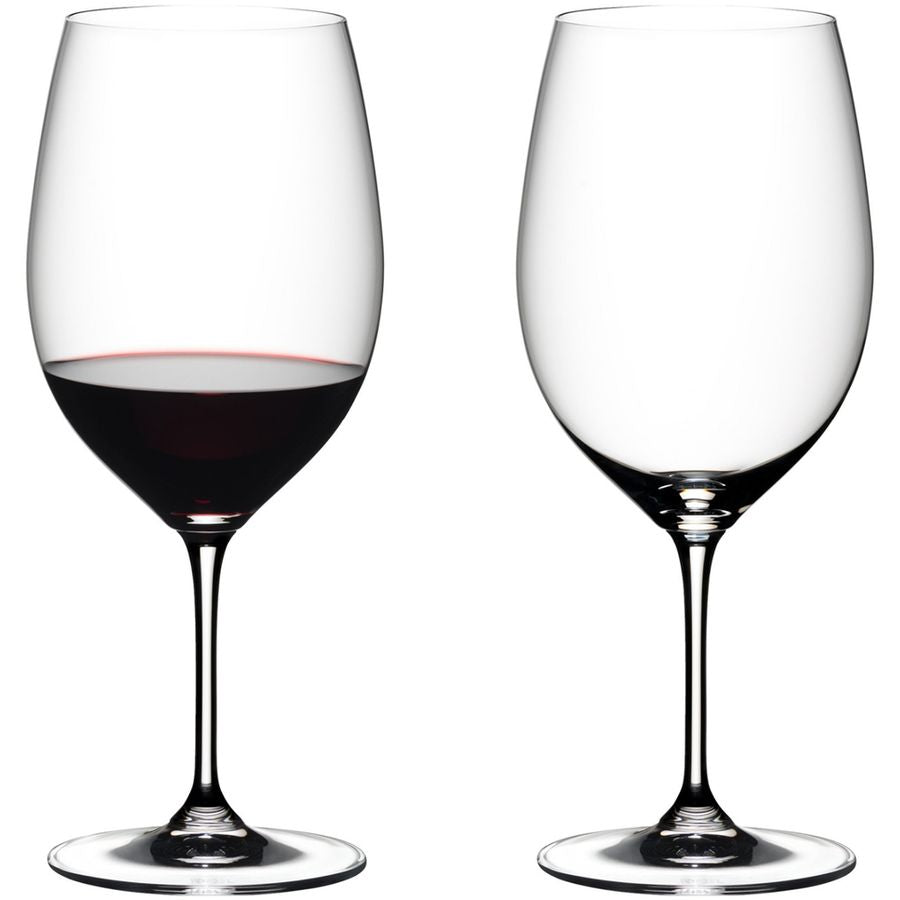 Reidel red wine glass with red wine, empty Reidel wine glass on white background.