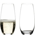 Reidel stemless wine glasses, one filled with sparkling wine, one empty.