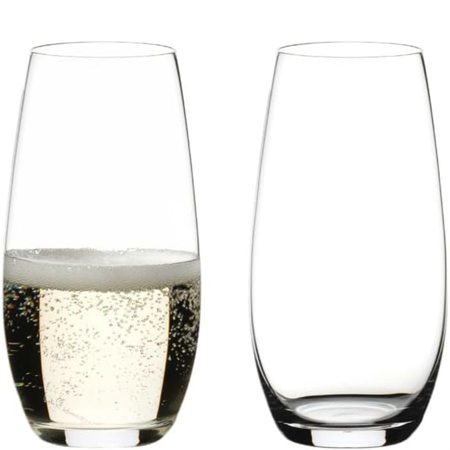 Reidel stemless wine glasses, one filled with sparkling wine, one empty.