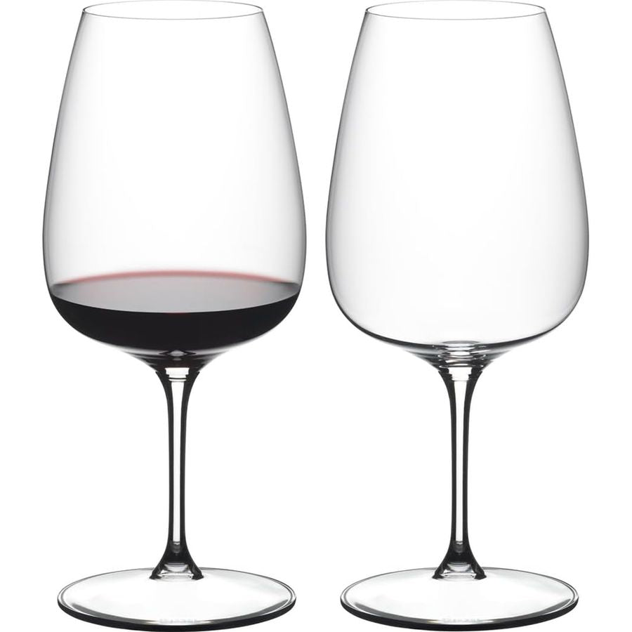 Reidel red wine glasses, one with red wine, clear crystal, stem design.