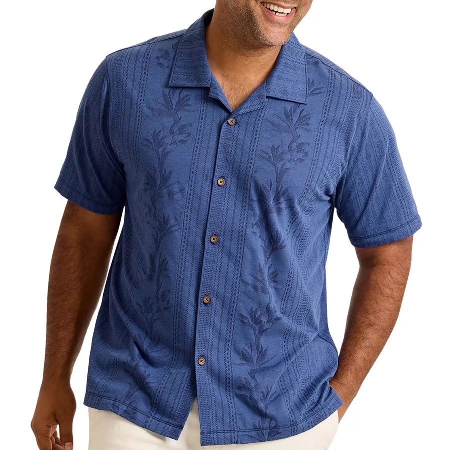 Man wearing a blue patterned shirt on a white background