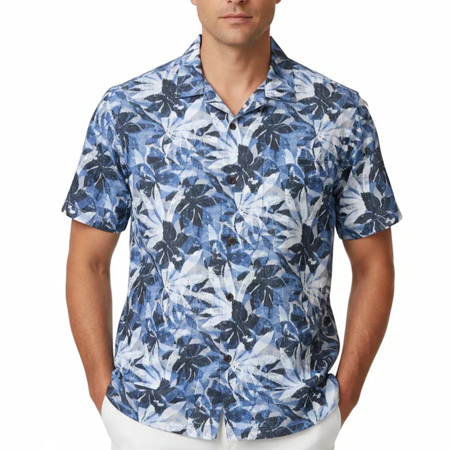 Man wearing a blue floral patterned shirt on a white background