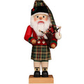 Traditional Scottish Santa Claus figurine with a kilt and bagpipes on a white background